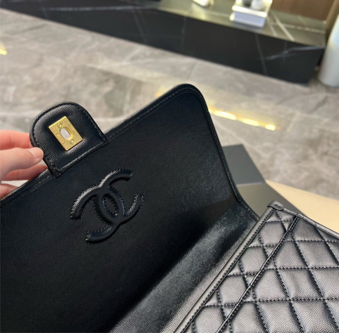 Woman Chanel black handbag